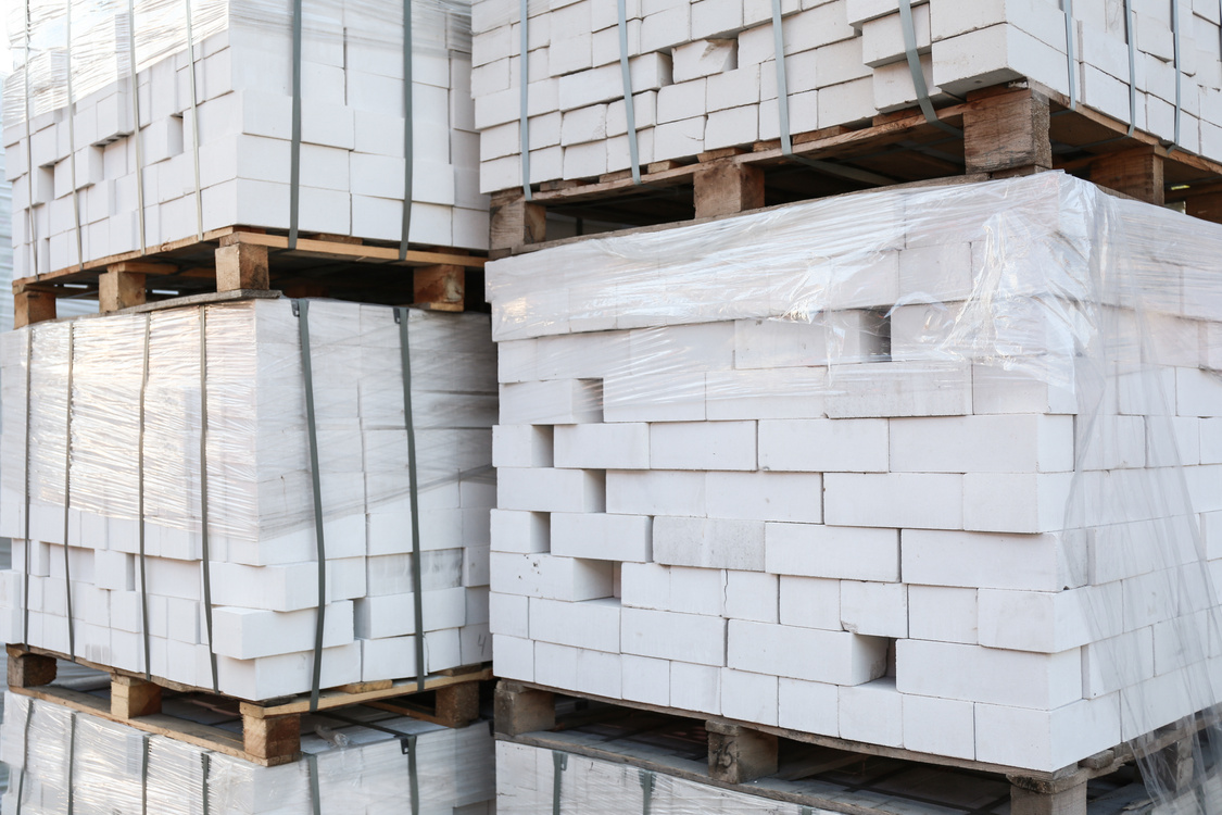 Pallets with White Bricks Outdoors. Building Materials Wholesale